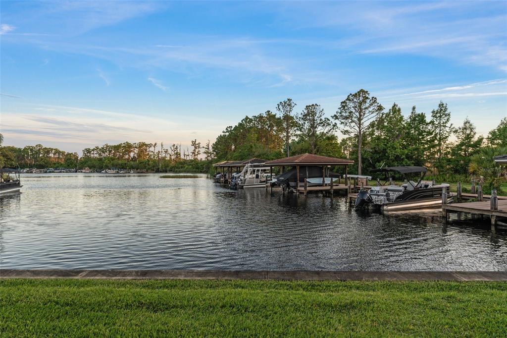 6206 Masters Boulevard, Unit 302 Orlando, FL 32819 - Photo 27 of 32 a view of a lake with houses in the back