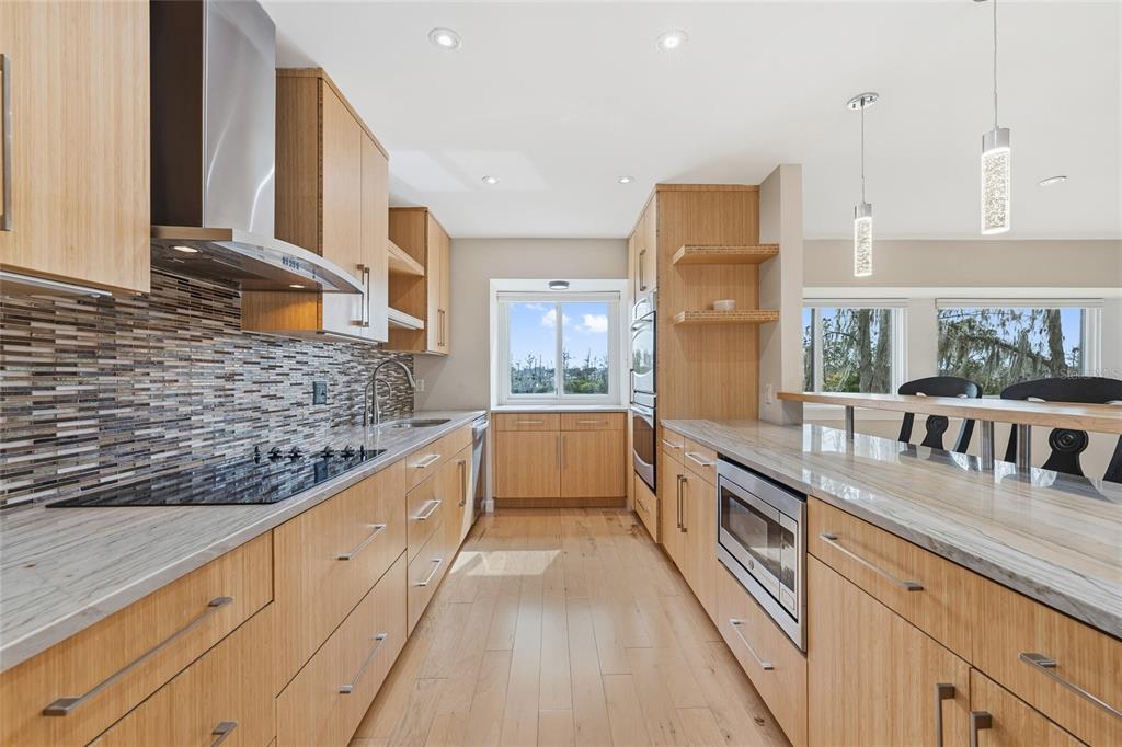 6206 Masters Boulevard, Unit 302 Orlando, FL 32819 - Photo 5 of 32 a large white kitchen with stainless steel appliances granite countertop a lot of counter space