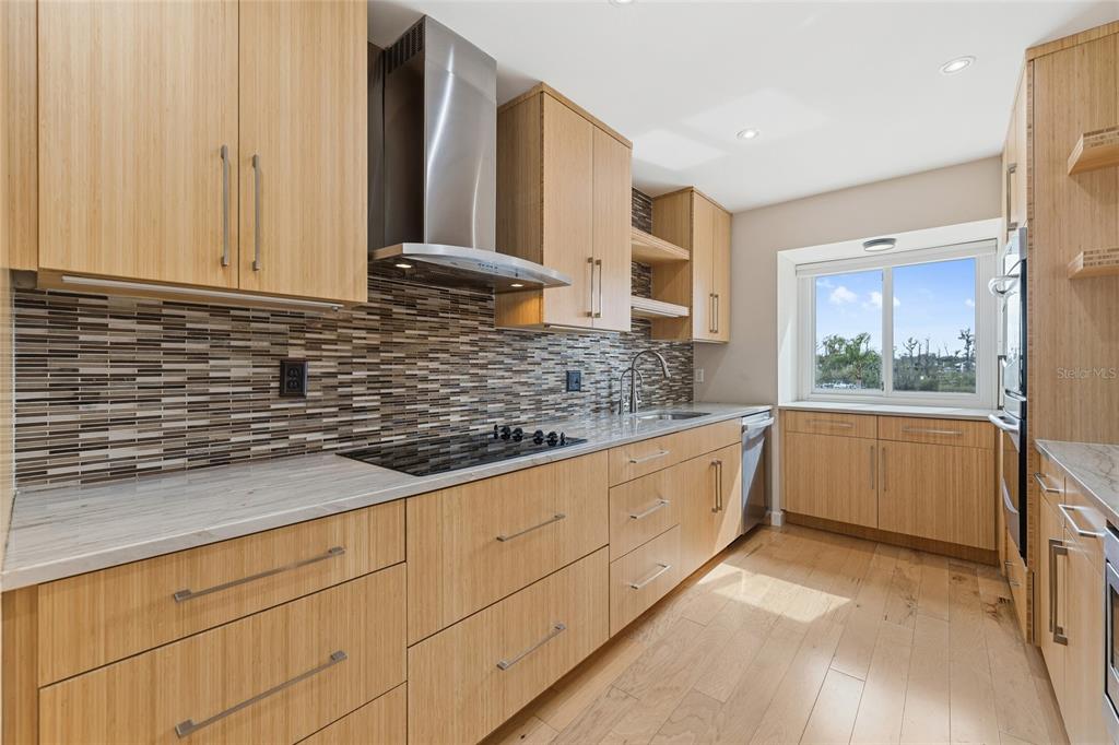 6206 Masters Boulevard, Unit 302 Orlando, FL 32819 - Photo 6 of 32 a kitchen with granite countertop white cabinets and white appliances