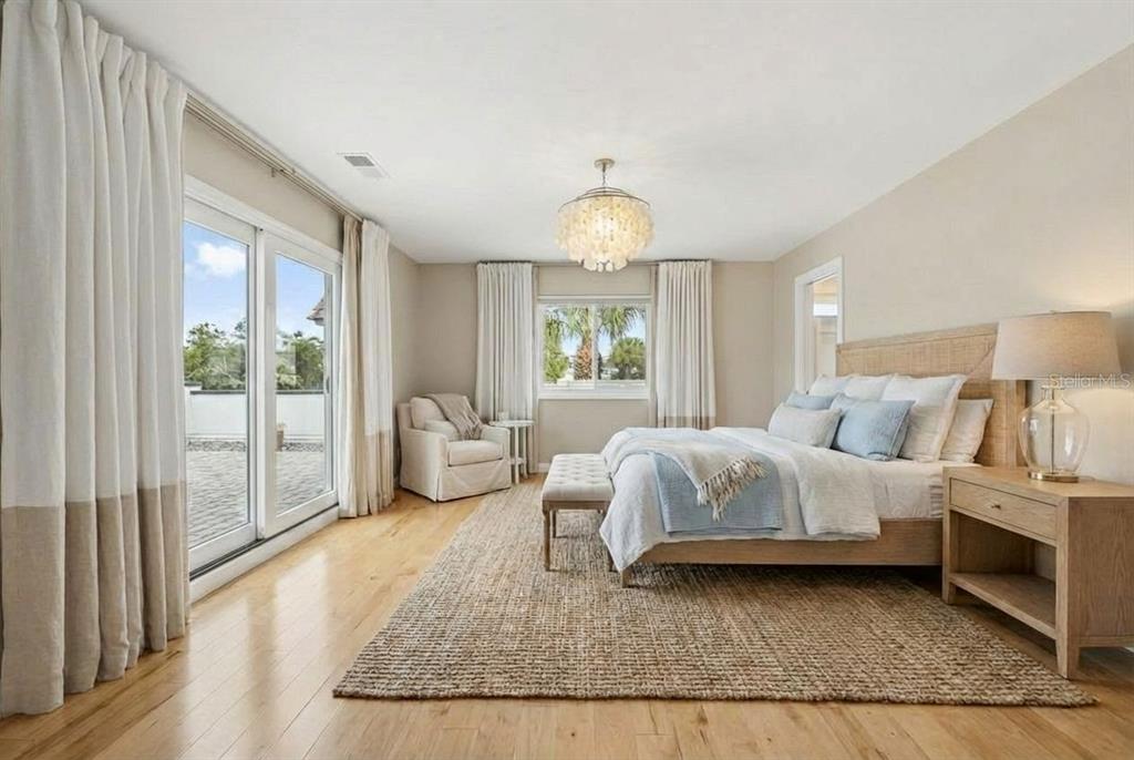 6206 Masters Boulevard, Unit 302 Orlando, FL 32819 - Photo 8 of 32 a spacious bedroom with a bed and large windows