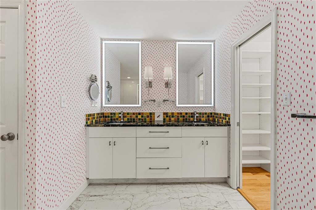 6206 Masters Boulevard, Unit 302 Orlando, FL 32819 - Photo 9 of 32 wooden bathroom with a granite countertop sink and a mirror