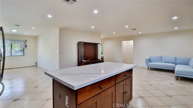 a kitchen with a sink granite counter top space and furniture