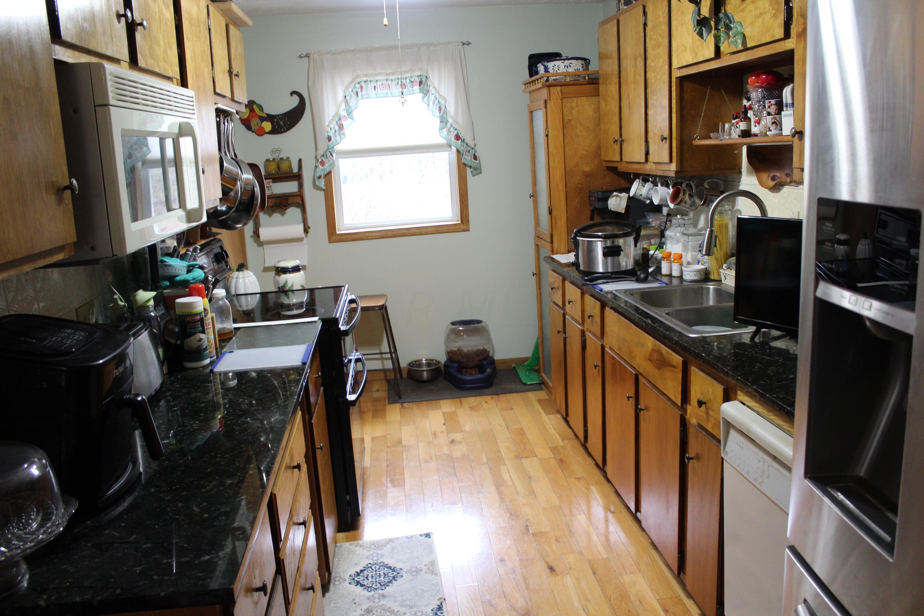 Beauriful wood floors and mostly SS appliances which convey