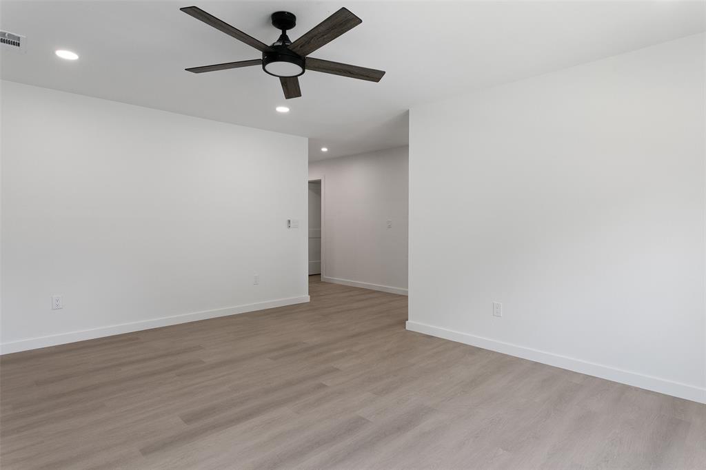 1346 South Reno Road Springtown, TX 76082 - Photo 8 of 24 Expansive interior space featuring wood-finish flooring, recessed lighting, a contemporary ceiling fan, and crisp white baseboards