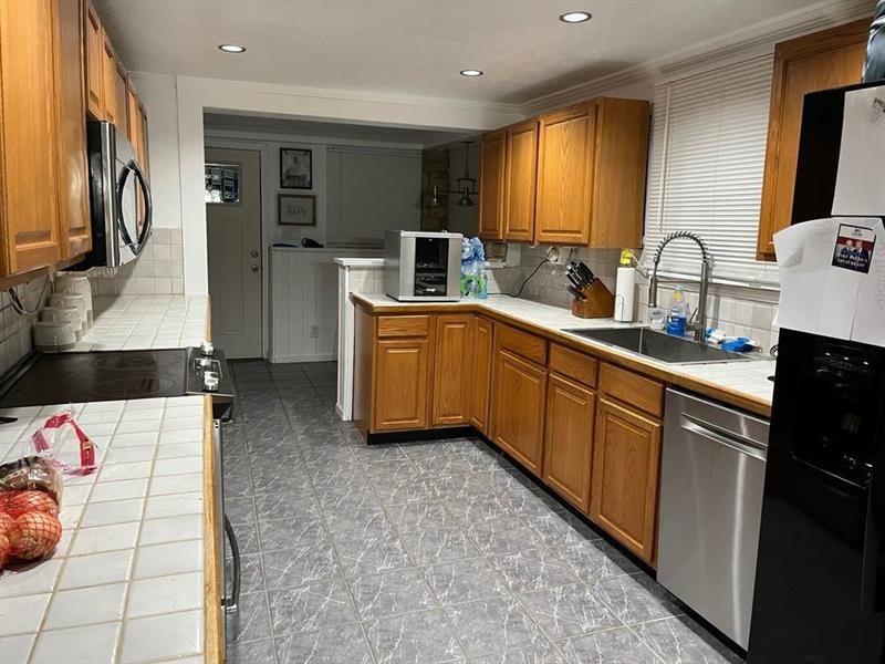 205 Stone Church Road Grindstone, PA 15442 - Photo 19 of 25 a kitchen with stainless steel appliances a sink and a refrigerator