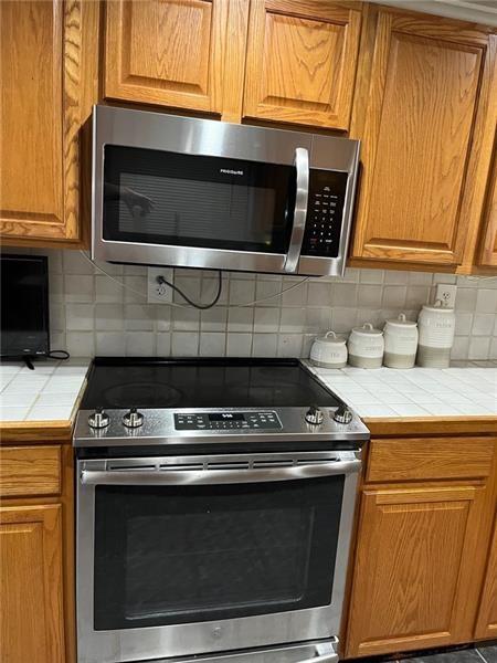 205 Stone Church Road Grindstone, PA 15442 - Photo 23 of 25 a kitchen with microwave cabinets and a stove top oven