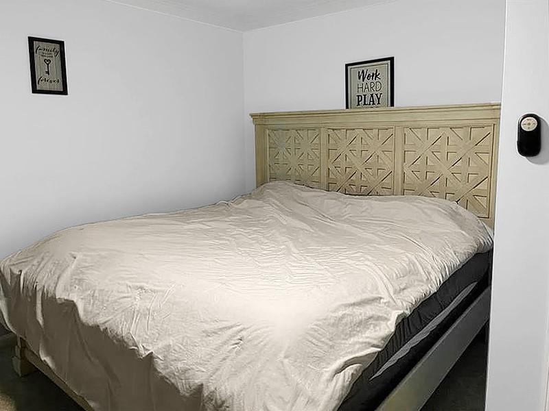 205 Stone Church Road Grindstone, PA 15442 - Photo 8 of 25 a large bed sitting in a bedroom with a wall painting