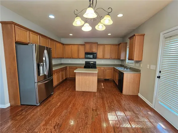 a kitchen with wooden cabinets and stainless steel appliances