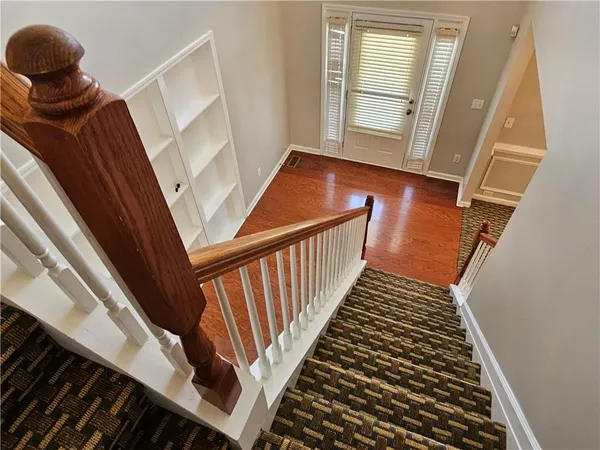 a view of entryway and hall with wooden floor