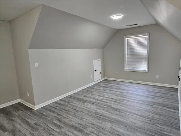 a view of a room with wooden floor