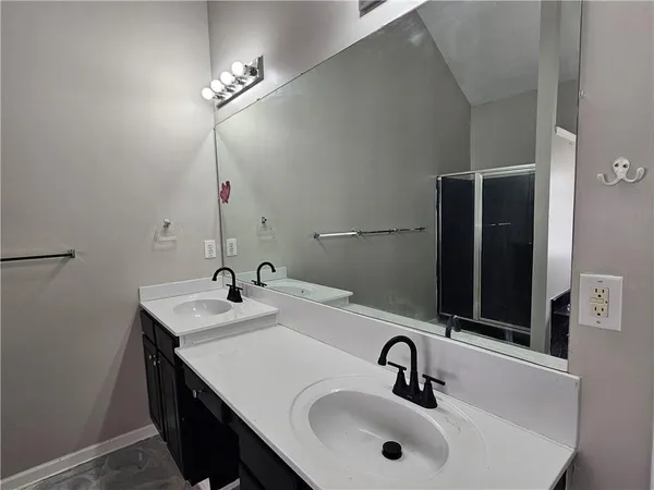 a bedroom with wooden floor and window