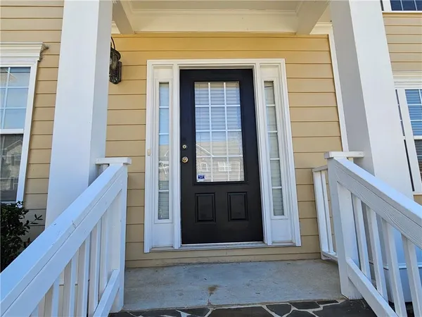 a view of a swimming pool with lawn chairs and wooden fence