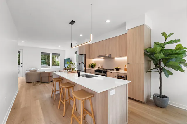 a kitchen with a sink a counter and chairs
