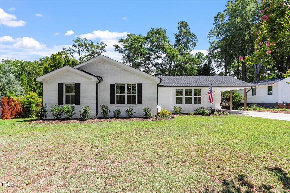 2222 Watkins Street Raleigh, NC 27604 - Photo 1 of 17 a front view of a house with a garden