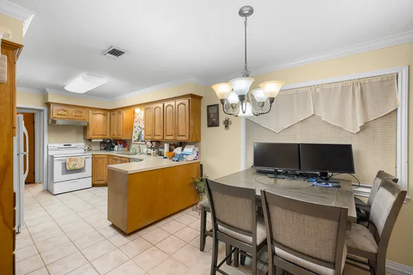 a kitchen with stainless steel appliances granite countertop a sink a stove and a refrigerator