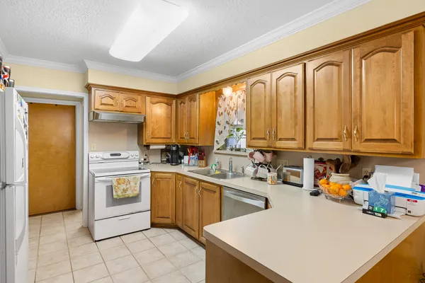 a kitchen with a sink a stove and cabinets