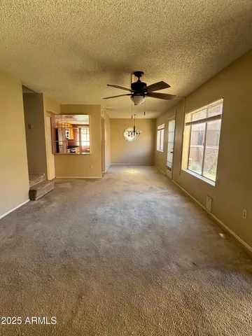 a view of a livingroom with a fireplace and a window