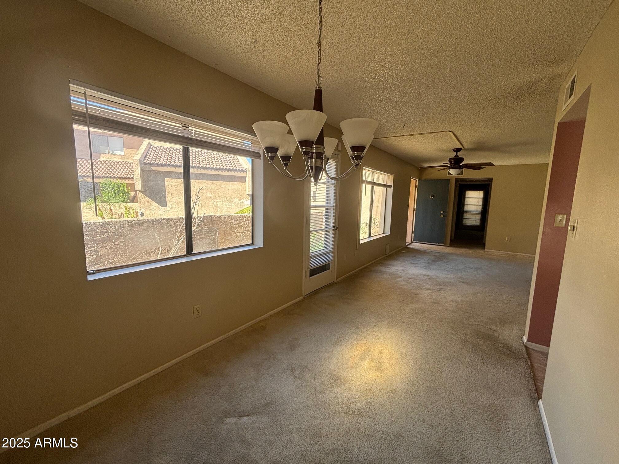 10828 North Biltmore Drive, Unit 154 Phoenix, AZ 85029 - Photo 6 of 23 a view of a livingroom with a ceiling fan and window