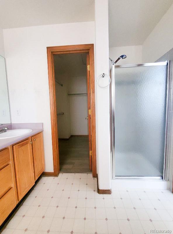 4934 South Danube Street Aurora, CO 80015 - Photo 18 of 22 a view of a bathroom with a sink and a mirror