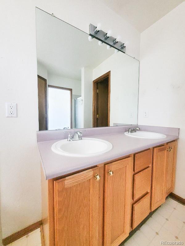 4934 South Danube Street Aurora, CO 80015 - Photo 19 of 22 a bathroom with a sink and a mirror