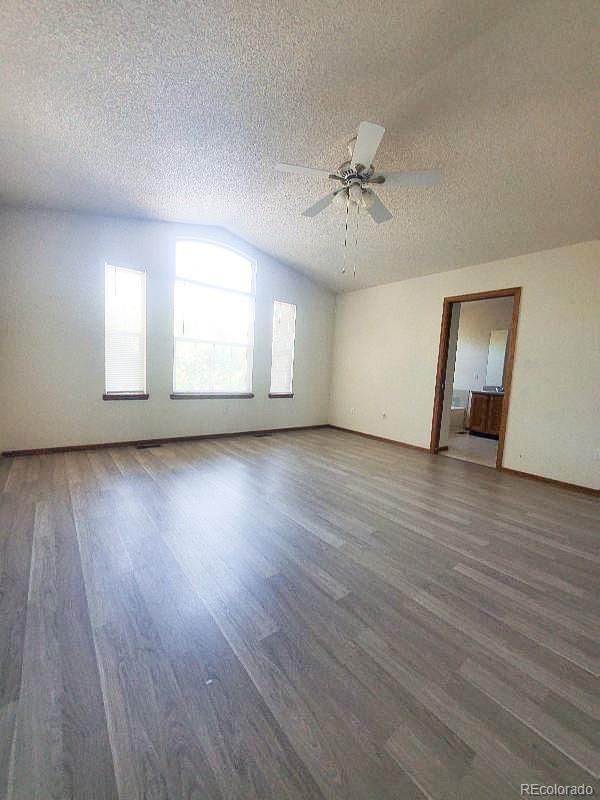 4934 South Danube Street Aurora, CO 80015 - Photo 4 of 22 a view of an empty room with wooden floor and a window