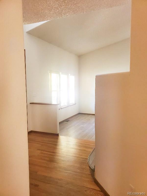 4934 South Danube Street Aurora, CO 80015 - Photo 6 of 22 a view of empty room with wooden floor