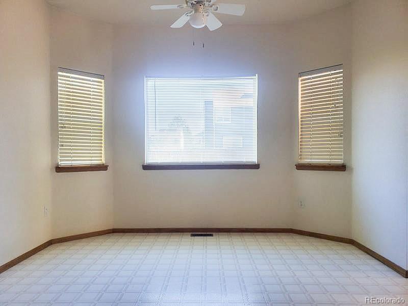 4934 South Danube Street Aurora, CO 80015 - Photo 9 of 22 an empty room with windows