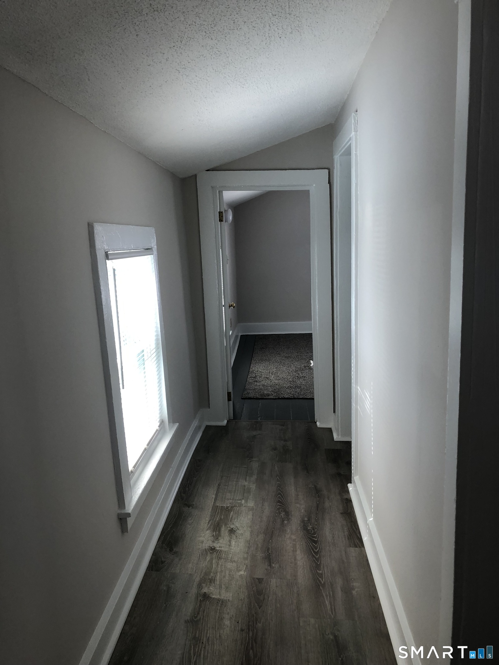 23 Taylor Street Torrington, CT 06790 - Photo 11 of 16 a view of a hallway with wooden floor