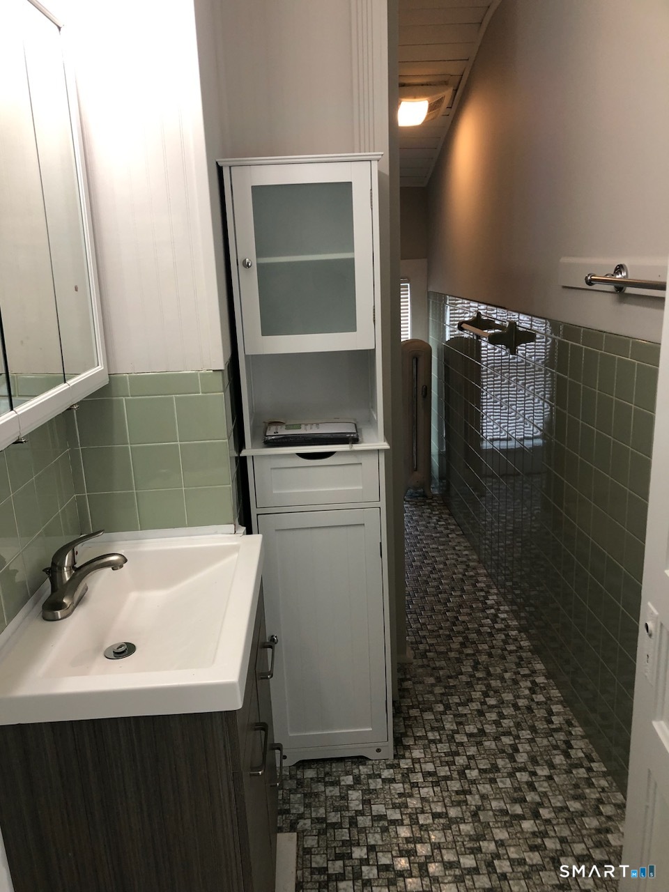 23 Taylor Street Torrington, CT 06790 - Photo 15 of 16 a bathroom with a sink a toilet and mirror