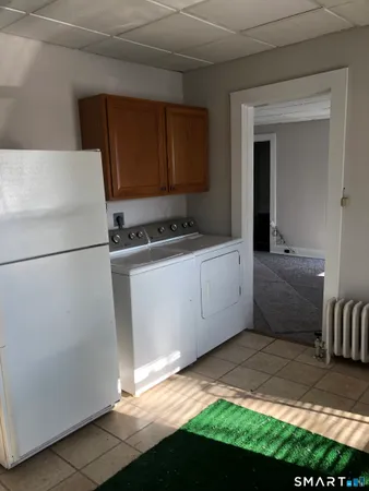 a kitchen with a refrigerator and a sink