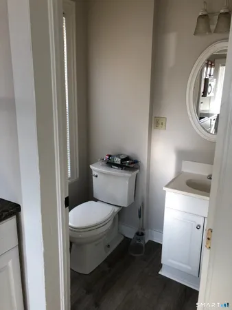 a white toilet sitting next to a bathroom sink