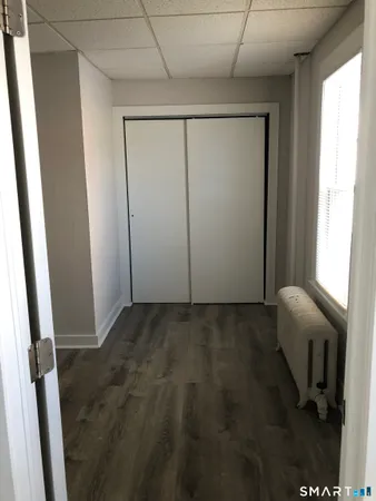 a view of a room with a wooden door and chair
