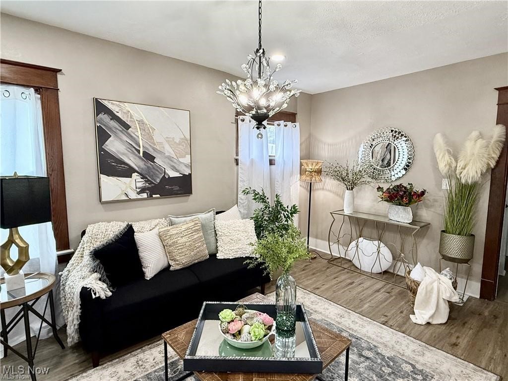 281 Sexton Street Struthers, OH 44471 - Photo 6 of 28 Living room featuring wood finished floors and a chandelier