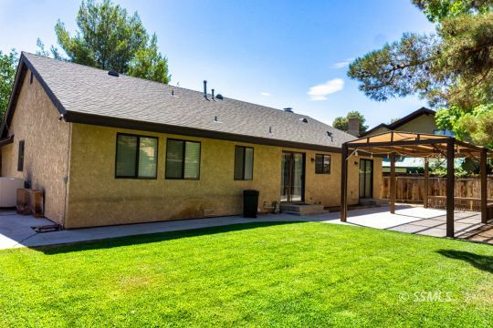 316 Mesquite Avenue Ridgecrest, CA 93555 - Photo 36 of 38 a front view of a house with a yard table and chairs