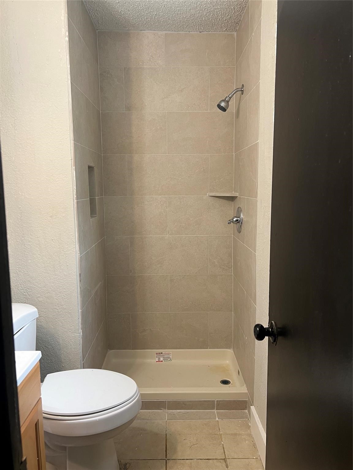 10902 Jutland Road Houston, TX 77048 - Photo 16 of 20 a bathroom with a granite countertop toilet and a shower