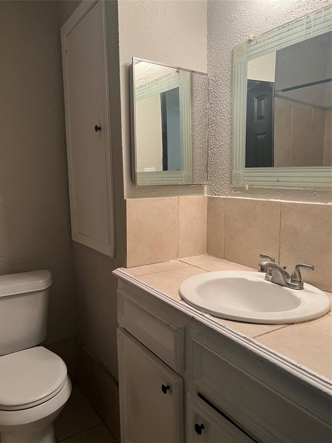 10902 Jutland Road Houston, TX 77048 - Photo 19 of 20 a bathroom with a sink toilet and mirror