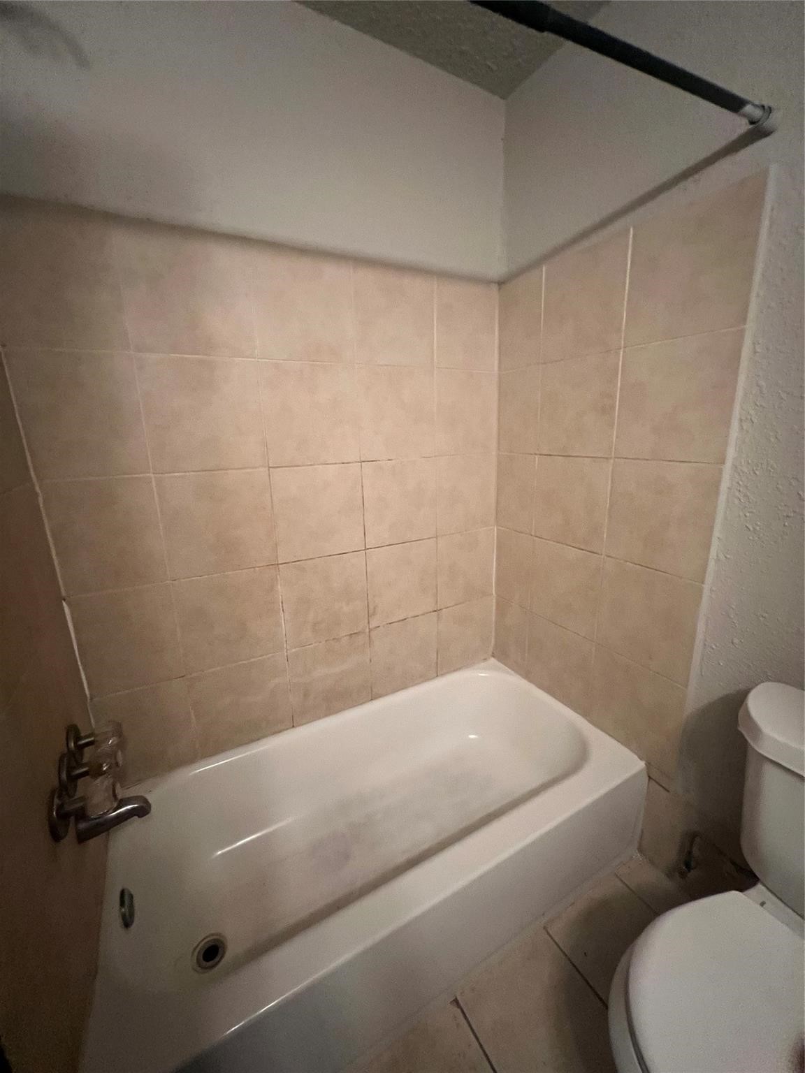 10902 Jutland Road Houston, TX 77048 - Photo 20 of 20 a bathroom with a toilet and a bathtub