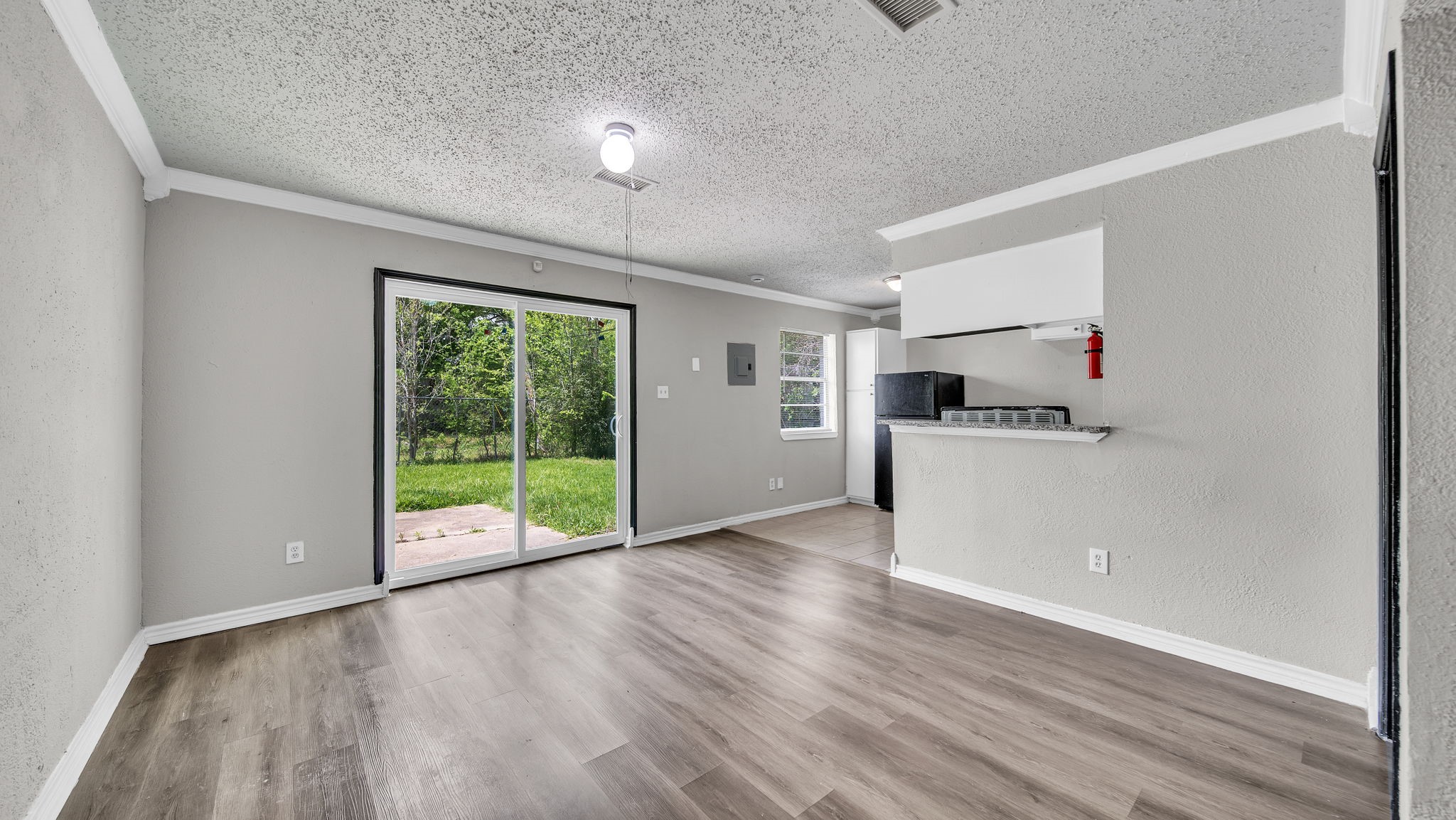 10902 Jutland Road Houston, TX 77048 - Photo 2 of 20 a view of an empty room with a window and wooden floor