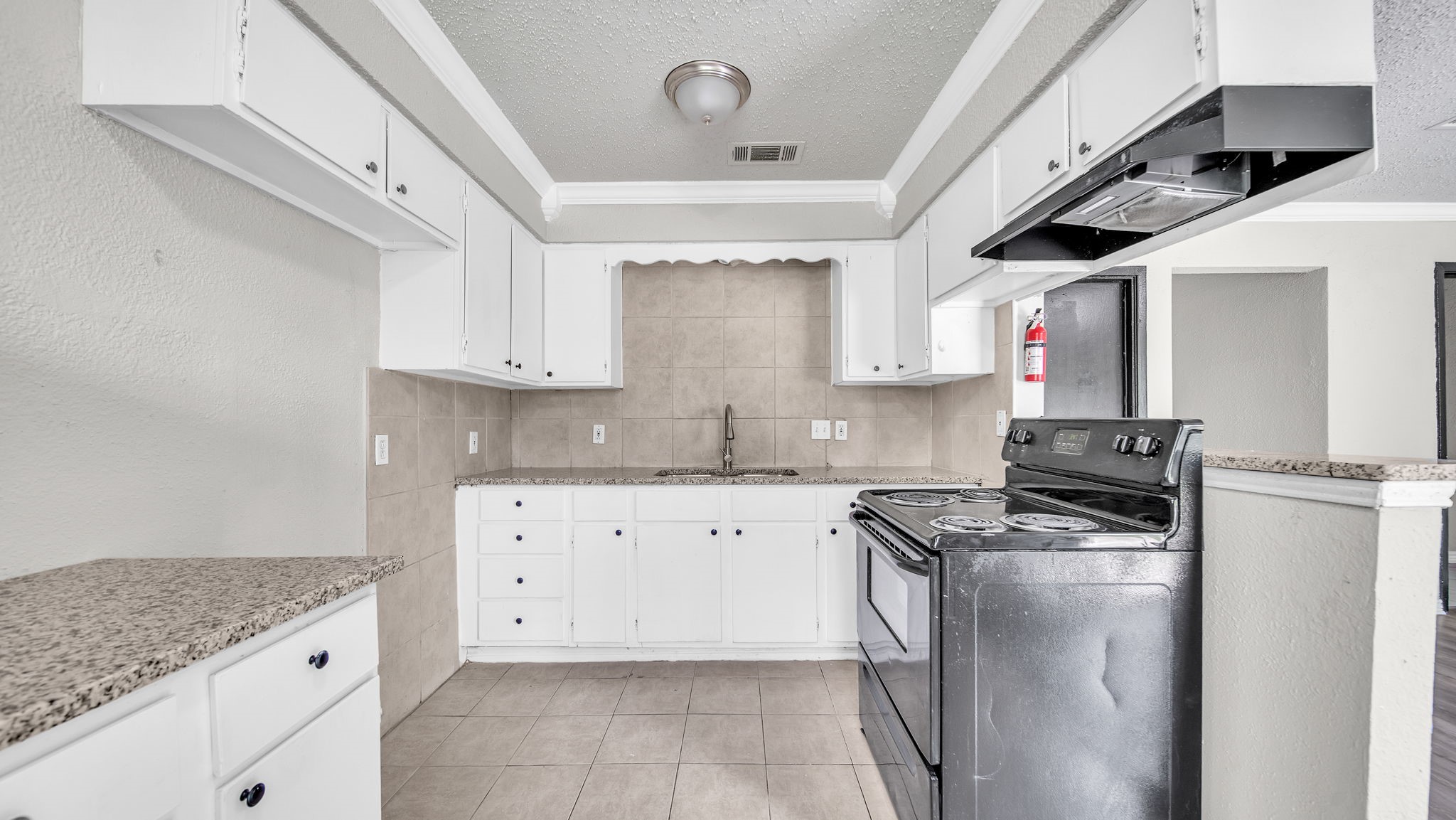 10902 Jutland Road Houston, TX 77048 - Photo 3 of 20 a kitchen with stainless steel appliances granite countertop a stove a sink and a refrigerator