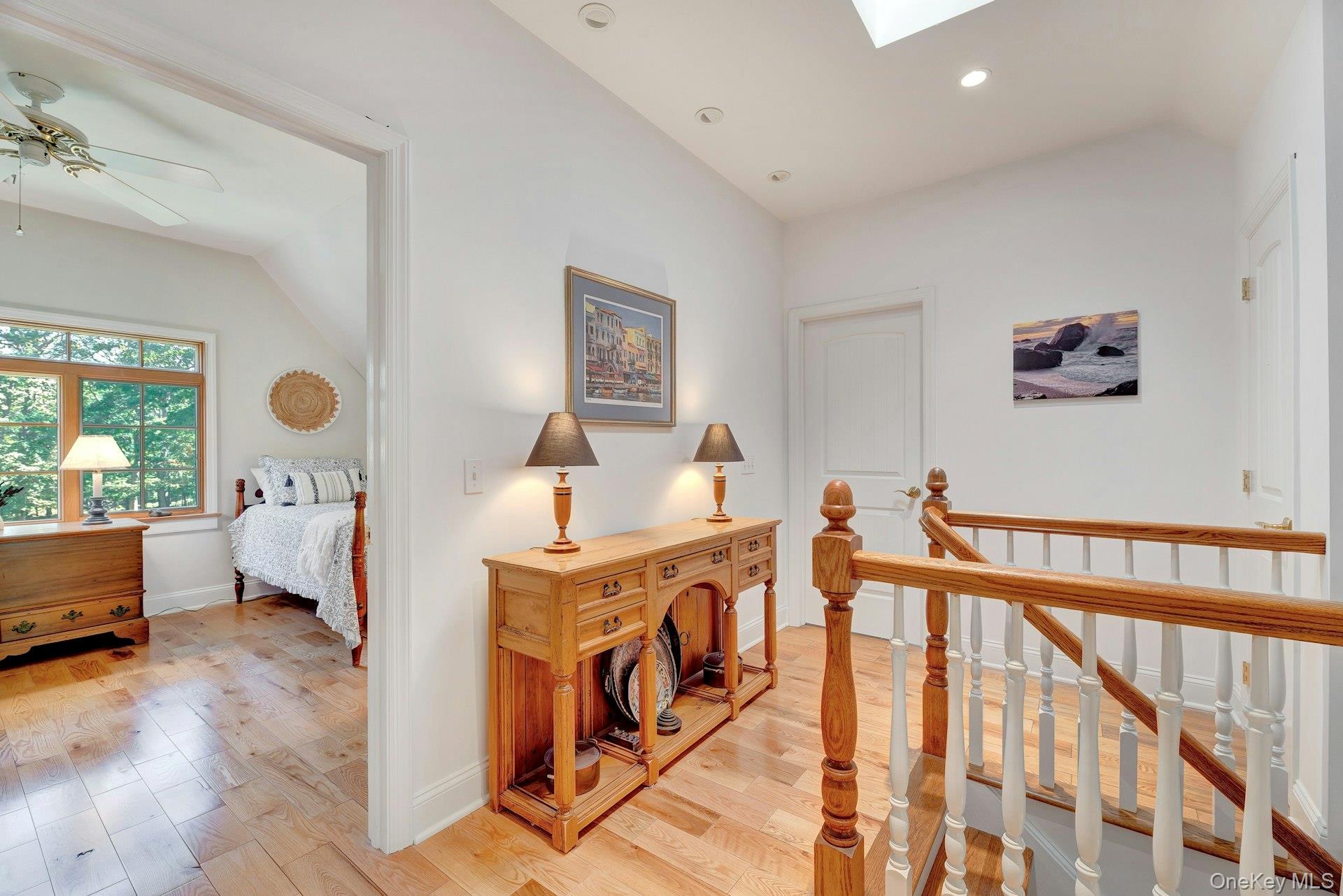 3600 Rocky Point Road East Marion, NY 11939 - Photo 24 of 45 Corridor featuring light wood-style flooring, an upstairs landing, a skylight, recessed lighting, and lofted ceiling