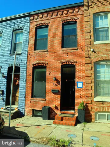 front view of a brick house with a yard