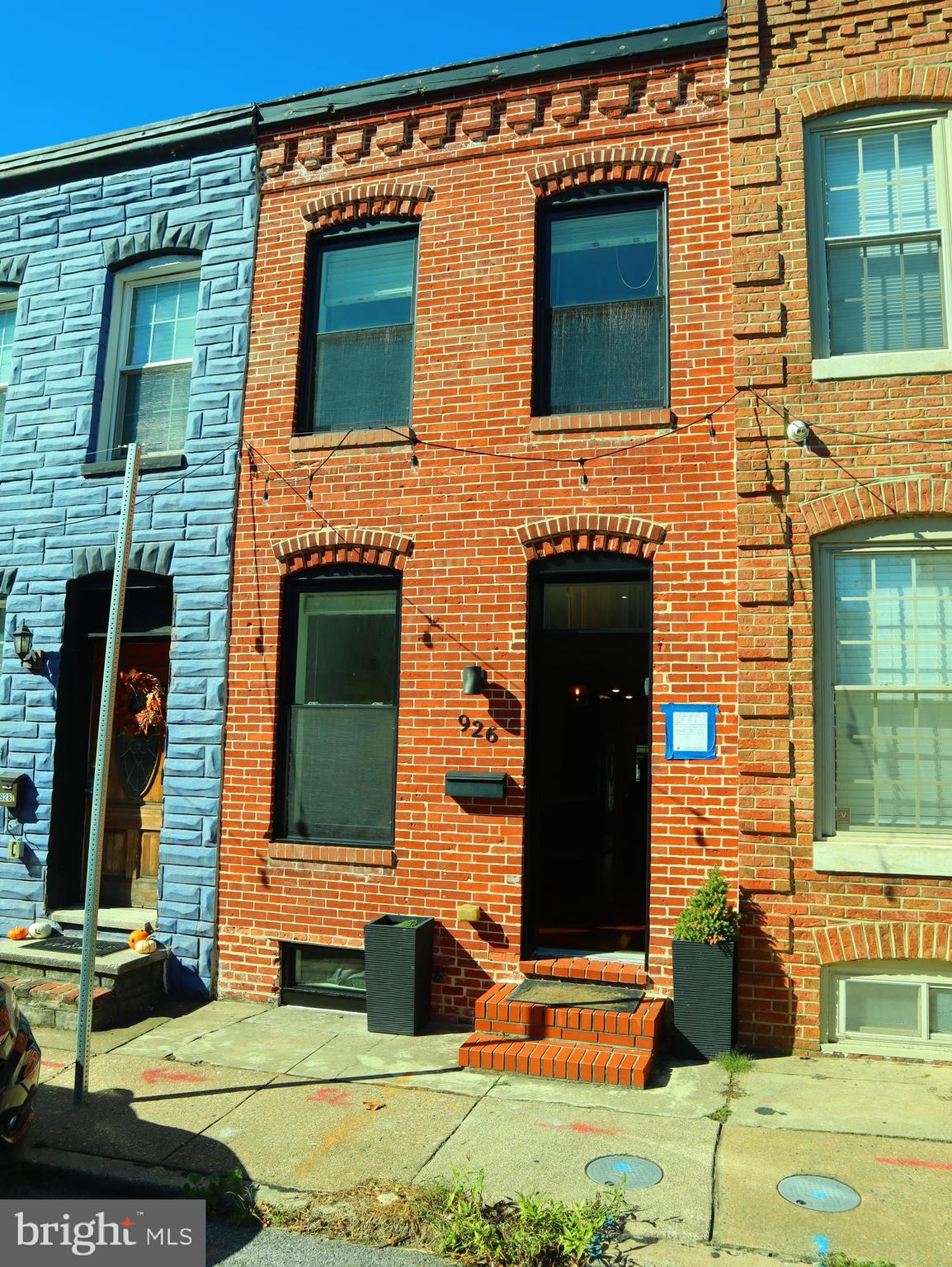 926 South Curley Street Baltimore, MD 21224 - Photo 24 of 25 front view of a brick house with a yard