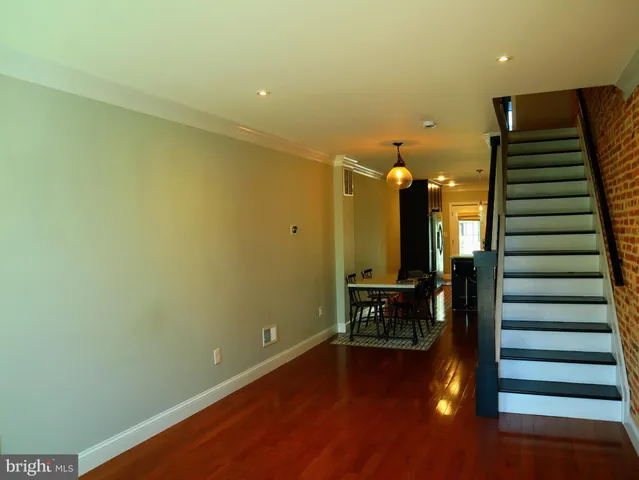 a view of a room with wooden floor