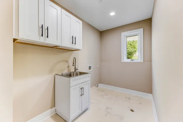 a kitchen with white cabinets and a sink