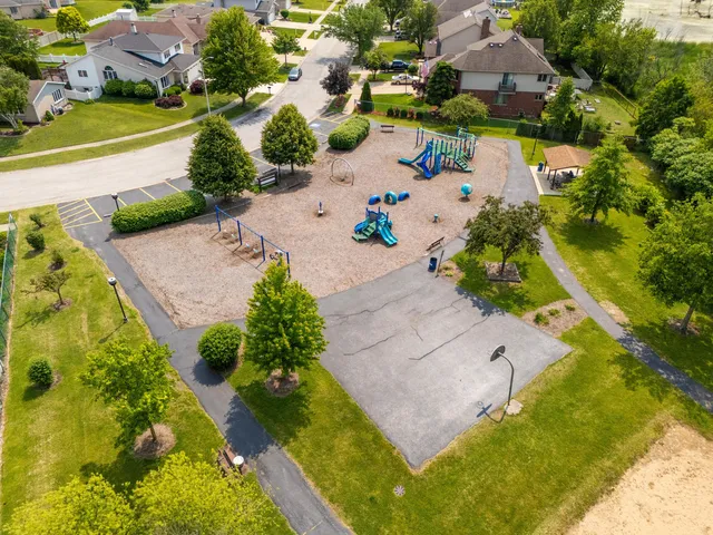 an aerial view of a house with a garden and swimming pool