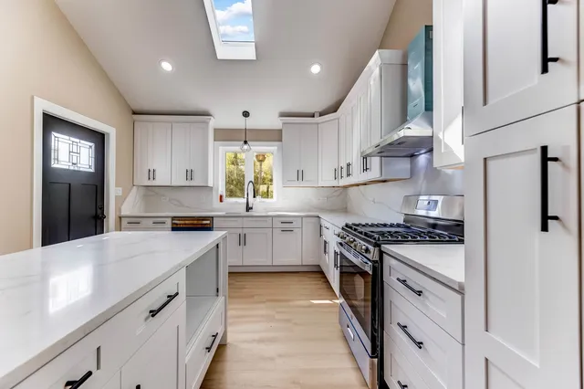 a kitchen with a stove a sink and a refrigerator