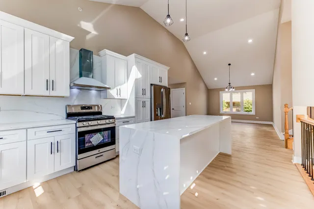 a large kitchen with stainless steel appliances
