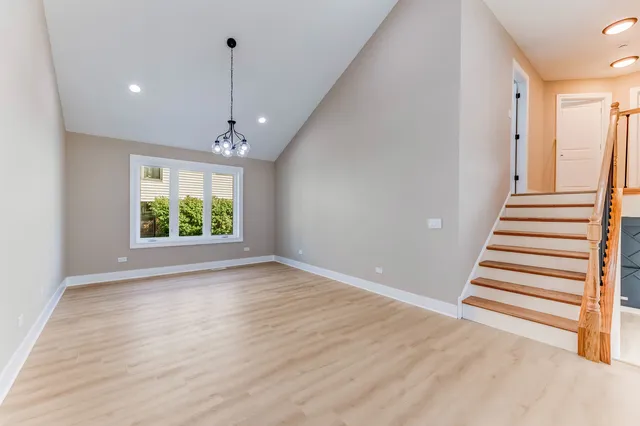 a view of a room with wooden floor and window