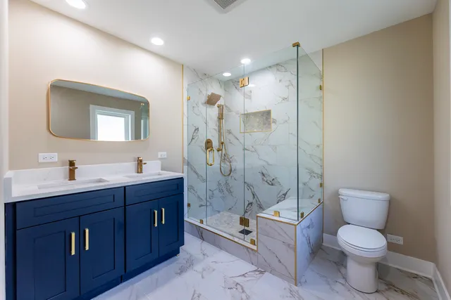 a bathroom with a toilet sink shower and mirror