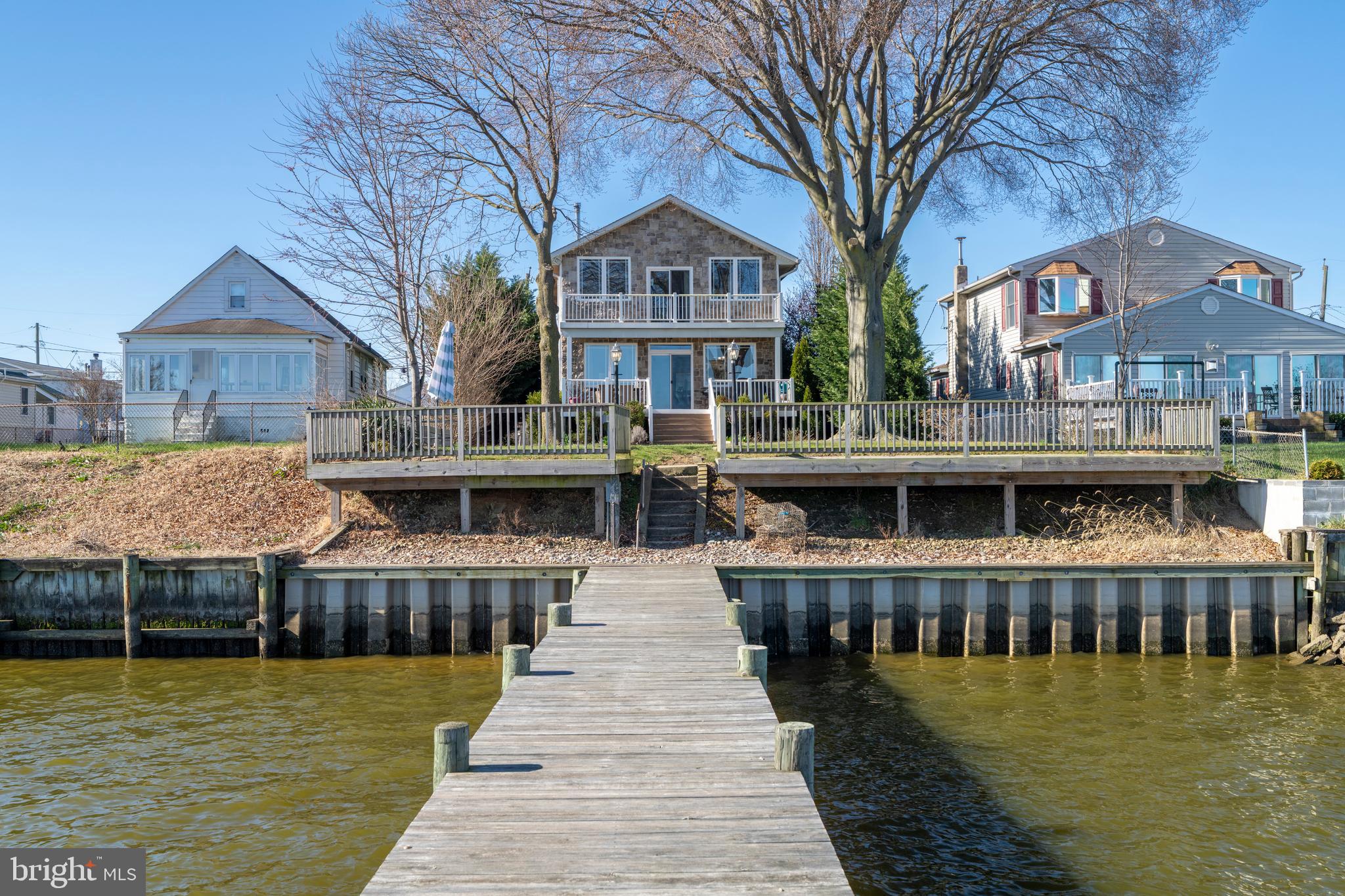a front view of residential houses with yard and lake view